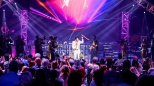 elvis impersonator on stage with audience watching